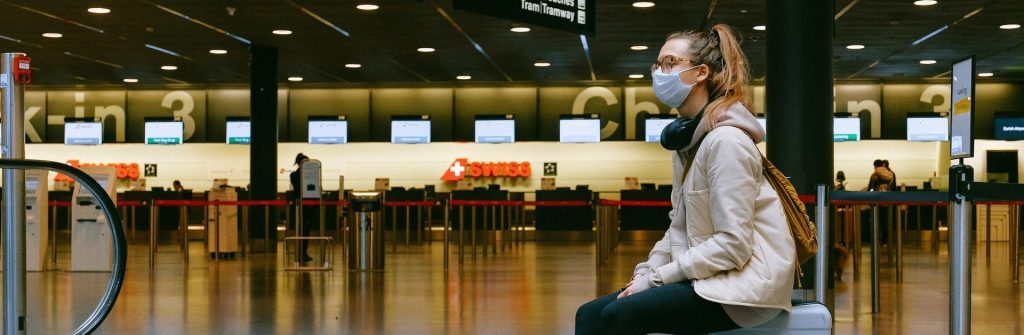 woman sitting on luggage 3943882 e1585144045189